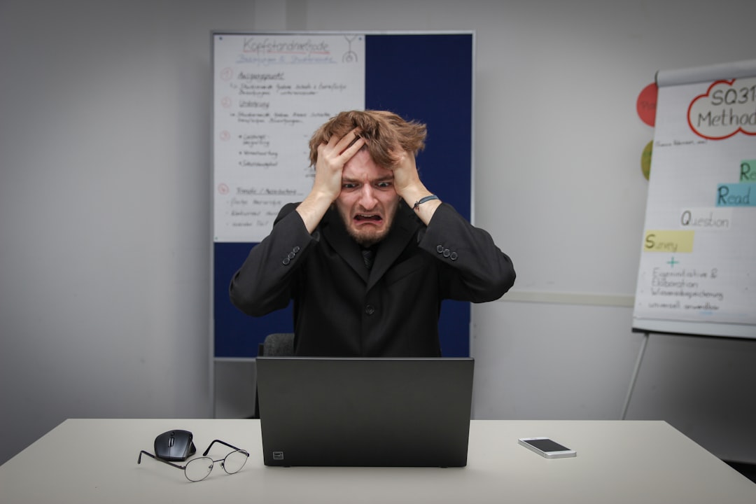 Trader managing emotions while analyzing forex charts on computer screen